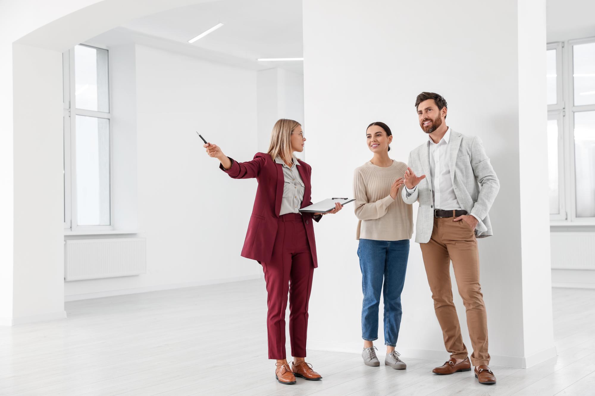 Agent showing a modern apartment interior to clients