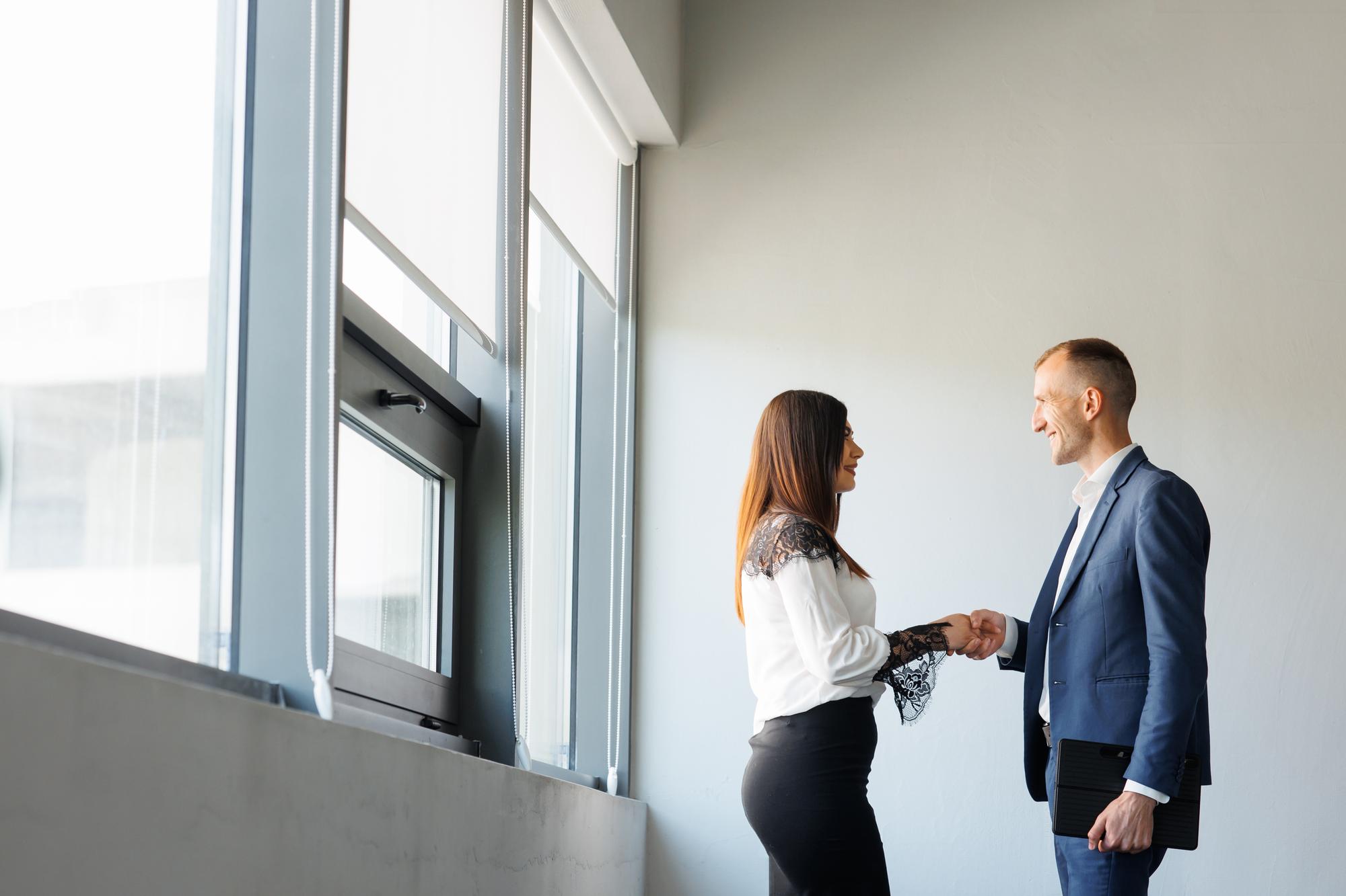 Agent handshake with client in a bright office